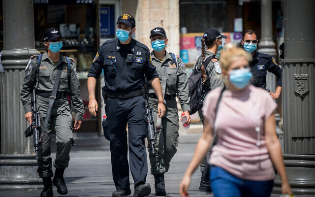 Israel Police officers enforce the emergency regulations on Jaffa Street in downtown Jerusalem on July 9, 2020. (Yonatan Sindel/Flash90) Israel Police officers enforce the emergency regulations on Jaffa Street in downtown Jerusalem on July 9, 2020. (Yonatan Sindel/Flash90)
