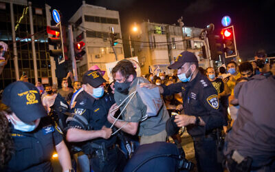 Protesters scuffle with police after a demonstration calling for financial support from the government amid the coronavirus crisis in Tel Aviv on July 11, 2020 (Miriam Alster/Flash90)