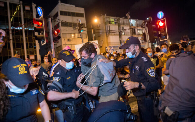 Protesters scuffle with police after a demonstration calling for financial support from the government amid the coronavirus crisis in Tel Aviv on July 11, 2020 (Miriam Alster/Flash90) Protesters scuffle with police after a demonstration calling for financial support from the government amid the coronavirus crisis in Tel Aviv on July 11, 2020 (Miriam Alster/Flash90)
