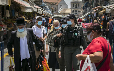 People wearing face masks market in Jerusalem, on July 14, 2020. (Olivier Fitoussi/Flash90)