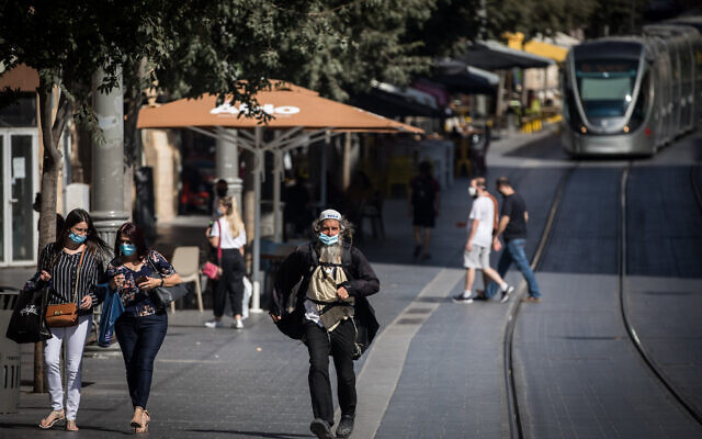 People wearing face masks on Jaffa Street in downtown Jerusalem on July 14, 2020. ( Yonatan Sindel/Flash90) People wearing face masks on Jaffa Street in downtown Jerusalem on July 14, 2020. ( Yonatan Sindel/Flash90)
