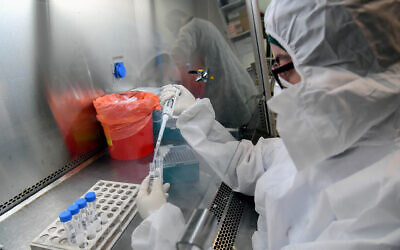 Technicians carry out a diagnostic test for coronavirus in a lab at Leumit Health Care Services branch in Or Yehuda, on July 14, 2020 (Yossi Zeliger/Flash90)