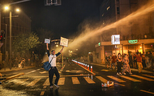 Police use water cannon on demonstrators during a protest against Prime Minister Benjamin Netanyahu outside Netanyahu's residence in Jerusalem, July 14, 2020. (Yonatan Sindel/Flash90) Police use water cannon on demonstrators during a protest against Prime Minister Benjamin Netanyahu outside Netanyahu's residence in Jerusalem, July 14, 2020. (Yonatan Sindel/Flash90)