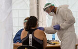 Illustrative: Medical workers test local residents at a temporary site to collect samples for coronavirus, in south Tel Aviv on July 16, 2020.(Flash90)
