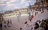 People enjoy the beach in Tel Aviv on July 18, 2020. (Miriam Alster/Flash90)