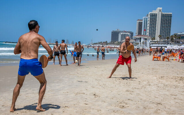 Israelis enjoy the beach in Tel Aviv on July 18, 2020 (Yossi Aloni/Flash90) Israelis enjoy the beach in Tel Aviv on July 18, 2020 (Yossi Aloni/Flash90)