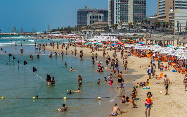 Israelis enjoy the beach in Tel Aviv on July 18, 2020 (Yossi Aloni/Flash90) Israelis enjoy the beach in Tel Aviv on July 18, 2020 (Yossi Aloni/Flash90)