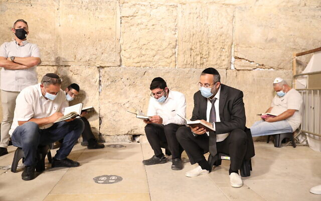 Jewish men pray at the Western Wall on the eve of Tisha B'Av in the Old City of Jerusalem, on July 29, 2020. (Olivier Fitoussi/Flash90) Jewish men pray at the Western Wall on the eve of Tisha B'Av in the Old City of Jerusalem, on July 29, 2020. (Olivier Fitoussi/Flash90)