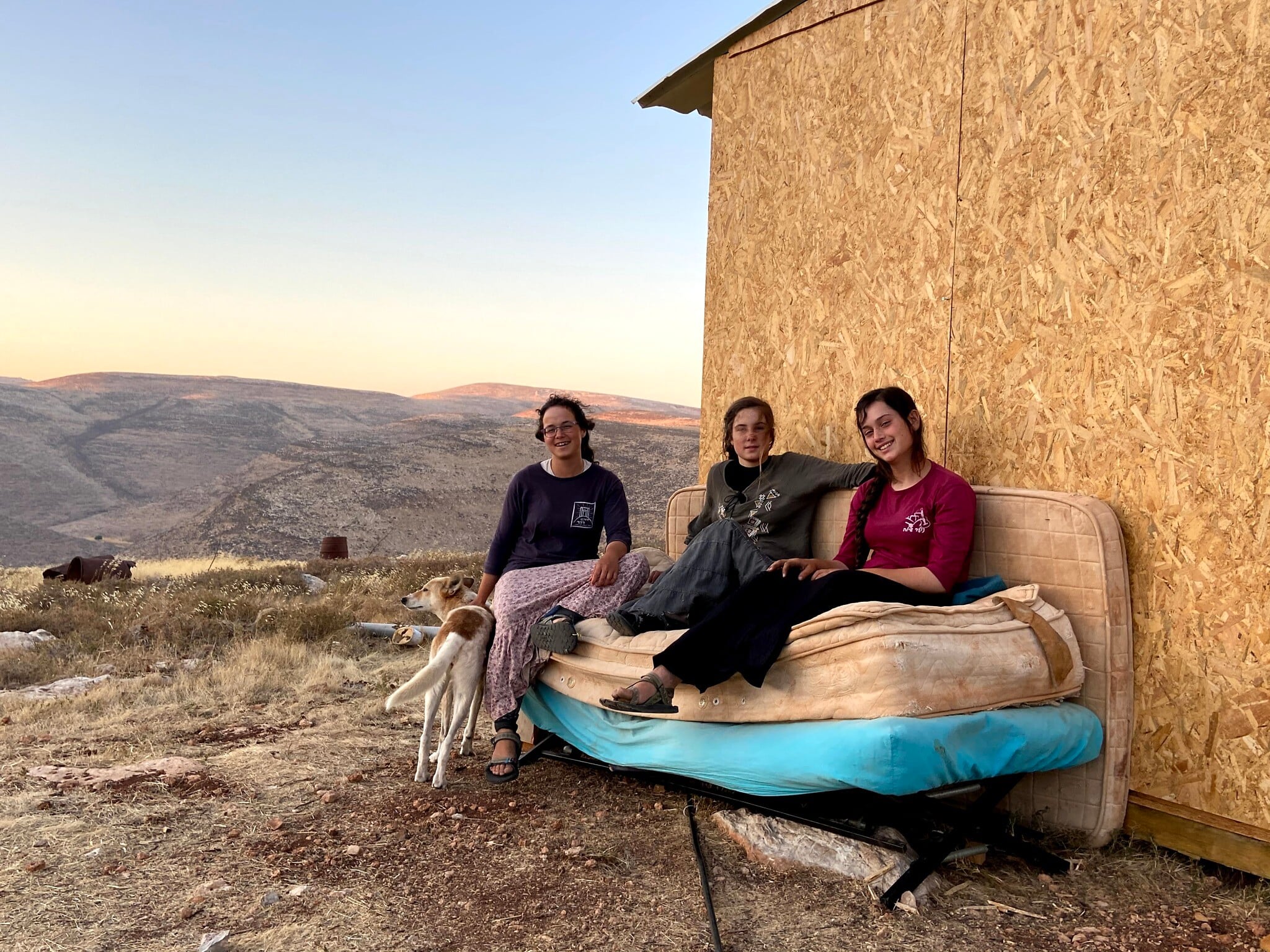 (From L-R) T'heeya Gozlan, Ora Hodaya and Shalhevet Goldstein in the Maoz Esther outpost on July 12, 2020. (Jacob Magid/Times of Israel) (From L-R) T'heeya Gozlan, Ora Hodaya and Shalhevet Goldstein in the Maoz Esther outpost on July 12, 2020. (Jacob Magid/Times of Israel)