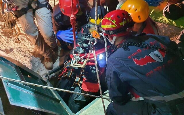 Rescue workers recover the body of a teen who drowned in a cistern near the West Bank settlement of Kedumim on July 2, 2020. (Liran Atias/Fire and Rescue Service)