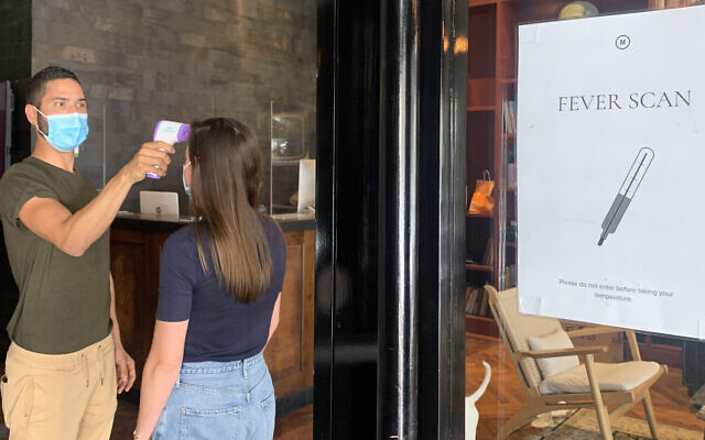 A worker entering a co-working space of Mindspace Ltd. amid pandemic concerns (Courtesy)