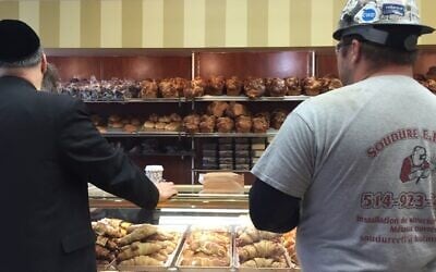 Two customers from diverse backgrounds ready to place their orders at Cheskies. (Ezra Soiferman/ www.EzraSoiferman.com)