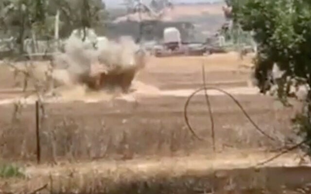 An Israel Police sapper detonates a suspected rocket-propelled grenade warhead, apparently flown into southern Israel from the Gaza Strip with a balloon, that was found in the Eshkol region on July 27, 2020. (Screen capture: Israel Police)