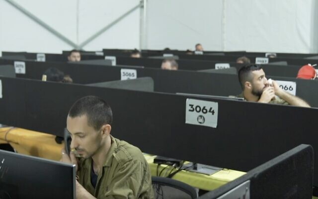 Illustrative: In a video released by the Israel Defense Forces on July 29, 2020, soldiers man the phones at the IDF Home Front Command's headquarters during a visit by coronavirus czar Prof. Ronni Gamzu. (Screen capture: Israel Defense Forces) Illustrative: In a video released by the Israel Defense Forces on July 29, 2020, soldiers man the phones at the IDF Home Front Command's headquarters during a visit by coronavirus czar Prof. Ronni Gamzu. (Screen capture: Israel Defense Forces)