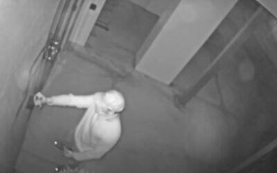 Screen capture from video of a person vandalizing the Temple Sinai synagogue in Sarasota, Florida, on July 15, 2020. (YouTube)