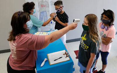 Illustrative: Teachers check students before a summer camp at Wylie High School in Wylie, Texas, July 14, 2020. (AP Photo/LM Otero)