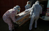 Funeral home workers carry the coffin of a woman who died from COVID-19 near Johannesburg, South Africa, July 21, 2020. (AP Photo/Themba Hadebe)