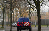 A car belonging to the Dutch security forces guards the Maimonides and Rosj Pina Jewish schools in Amsterdam, November 25, 2019. (Canaan Lidor)