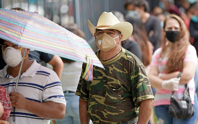 People wait in line at a free COVID-19 testing site provided by United Memorial Medical Center, at the Mexican Consulate in Houston, Texas, June 28, 2020. (AP Photo/David J. Phillip) People wait in line at a free COVID-19 testing site provided by United Memorial Medical Center, at the Mexican Consulate in Houston, Texas, June 28, 2020. (AP Photo/David J. Phillip)