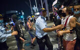 Israelis and police at an anti-government protest in Tel Aviv, on July 28, 2020. (Miriam Alster/Flash90)