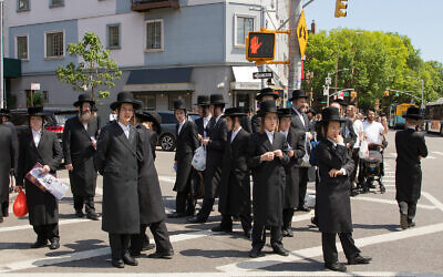 Williamsburg residents look on as protesters pass through their Brooklyn neighborhood, June 12, 2020. (Avi Kaye via JTA)