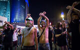 Self-employed Israelis block a road in Tel Aviv, during a protest calling for financial support from the government, July 11, 2020. (Miriam Alster/Flash90)