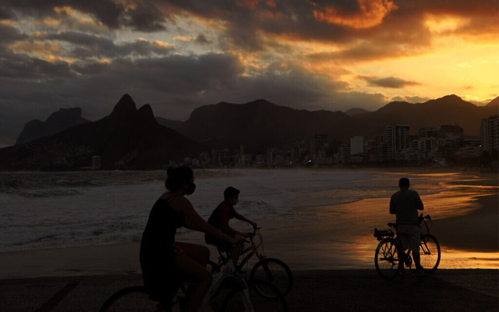 Cyclists wear face masks on Ipanema beach in Rio de Janeiro, Brazil, July 2, 2020. (Carl de Souza/AFP) Cyclists wear face masks on Ipanema beach in Rio de Janeiro, Brazil, July 2, 2020. (Carl de Souza/AFP)