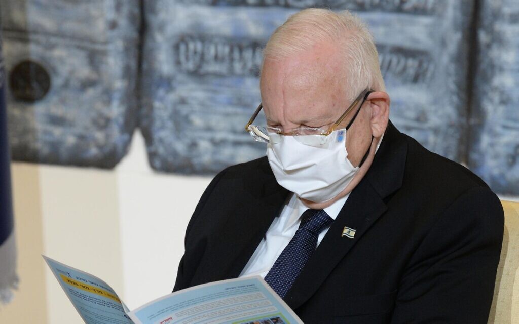 President Reuven Rivlin reads a report on the state of young people at risk during the coronavirus pandemic prepared by the Elem organization on July 6, 2020. (Mark Neyman/GPO) President Reuven Rivlin reads a report on the state of young people at risk during the coronavirus pandemic prepared by the Elem organization on July 6, 2020. (Mark Neyman/GPO)