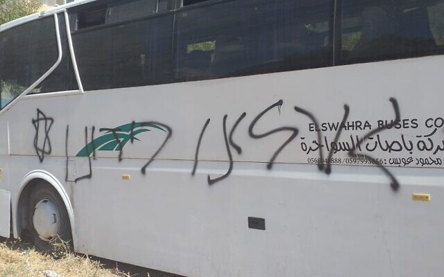 A bus in Luban a-Sharqiya spray-painted with the Hebrew phrase 'we must take our fate into our own hands,' in an apparent price tag hate crime attack on July 9, 2020. (Luban a-Sharqiya municipality) A bus in Luban a-Sharqiya spray-painted with the Hebrew phrase 'we must take our fate into our own hands,' in an apparent price tag hate crime attack on July 9, 2020. (Luban a-Sharqiya municipality)