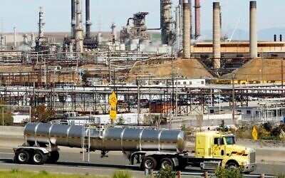 A tanker truck passes the Chevron oil refinery in Richmond, California, on March 9, 2010. (AP Photo/Paul Sakuma, File)