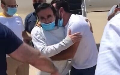 Kassim Tajideen (C) arrives back in Beirut after he was sentenced last year in a US federal court for laundering money for Hezbollah, July 8, 2020 (Screen grab/LBC)