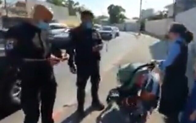 Police stop a young ultra-Orthodox girl in Jerusalem for failing to wear a face mask properly, July 6, 2020 (Screen grab/Twitter) Police stop a young ultra-Orthodox girl in Jerusalem for failing to wear a face mask properly, July 6, 2020 (Screen grab/Twitter)