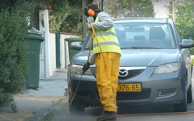 Spraying an Israeli street with weedkiller. (YouTube screenshot) Spraying an Israeli street with weedkiller. (YouTube screenshot)