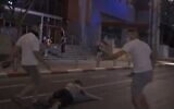 Screen grab from video appearing to show attacks on protesters by suspected right-wing activists in Tel Aviv, July 28, 2020 (Screen grab/Facebook)
