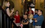 A group takes a tour of the Tenement Museum, which tells the stories of Jewish and other immigrants to New York, in 2008. (Kiko Niwa via JTA)