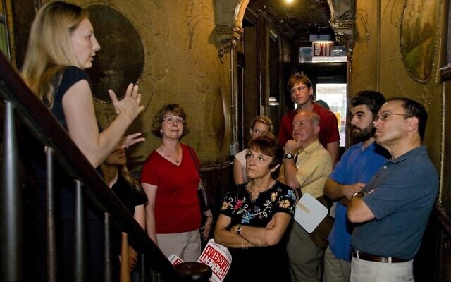 A group takes a tour of the Tenement Museum, which tells the stories of Jewish and other immigrants to New York, in 2008. (Kiko Niwa via JTA)