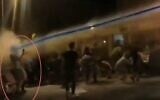 The moment a demonstrator is hit in the face with a stream of liquid from a water cannon at a demonstration against Prime Minister Benjamin Netanyahu in Jerusalem, July 2020 (Screen grab/Channel 12)