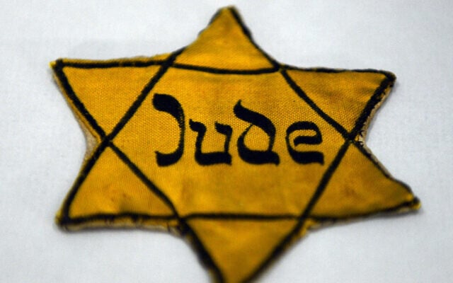 The yellow star, which Jews were forced to wear under Nazi rule, reads 'Jew', on display in a vitrine at the memorial place Wewelsburg in Bueren-Wewelsburg, Germany, 22 January 2015. (Caroline Seidel/picture alliance via Getty Images via JTA) The yellow star, which Jews were forced to wear under Nazi rule, reads 'Jew', on display in a vitrine at the memorial place Wewelsburg in Bueren-Wewelsburg, Germany, 22 January 2015. (Caroline Seidel/picture alliance via Getty Images via JTA)