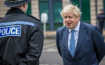Britain's Prime Minister Boris Johnson speaks to police officers during a visit to North Yorkshire Police headquarters in Northallerton, northeast England on July 30, 2020. (Charlotte Graham / POOL / AFP)
