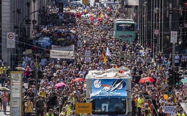 Thousands of demonstrators march down the Friedrichstrasse street as they take part in a demonstration against the current measures to curb the spread of the Coronavirus, in Berlin, on August 1, 2020. (John MACDOUGALL / AFP) Thousands of demonstrators march down the Friedrichstrasse street as they take part in a demonstration against the current measures to curb the spread of the Coronavirus, in Berlin, on August 1, 2020. (John MACDOUGALL / AFP)