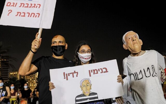 A protester wearing a face mask of Prime Minister Benjamin Netanyahu takes part in a demonstration against the government in Tel Aviv on August 1, 2020. (Jack Guez/AFP) A protester wearing a face mask of Prime Minister Benjamin Netanyahu takes part in a demonstration against the government in Tel Aviv on August 1, 2020. (Jack Guez/AFP)