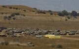 Military vehicles are amassed in the Golan Heights on August 3, 2020. (JALAA MAREY / AFP)