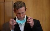 Stephan Ernst, who is accused of murdering politician Walter Luebcke, takes off his face mask at his trial at the Oberlandesgericht Frankfurt courthouse, in Frankfurt, Germany August 5, 2020. (KAI PFAFFENBACH / POOL / AFP)