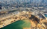 An aerial view taken on August 7, 2020, shows a partial view of the port of Beirut and the crater caused by the colossal explosion three days earlier of a huge pile of ammonium nitrate that had languished for years in a port warehouse, left scores of people dead or injured and caused devastation in the Lebanese capital. (AFP)