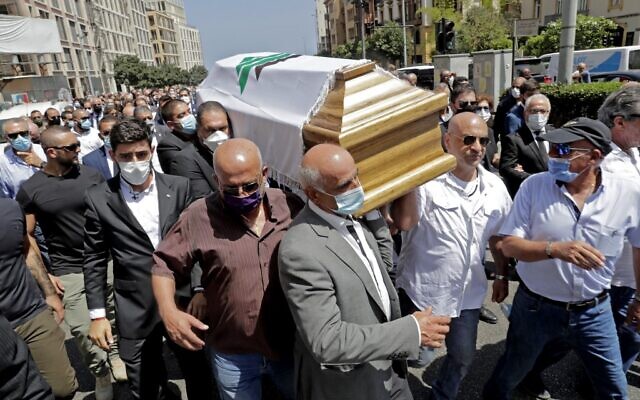 Members of the Lebanese Kataeb party carry the coffin of their party's secretary-general Nazar Najarian, killed by the explosion that hit the seaport of Beirut on August 4, during his funeral procession in the capital Beirut, on August 8, 2020. (ANWAR AMRO / AFP) Members of the Lebanese Kataeb party carry the coffin of their party's secretary-general Nazar Najarian, killed by the explosion that hit the seaport of Beirut on August 4, during his funeral procession in the capital Beirut, on August 8, 2020. (ANWAR AMRO / AFP)