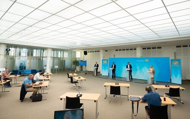 Journalists keep their distance as per coronavirus pandemic regulations while they take notes during a press conference, after a video conference of the Bavarian Cabinet at the Bavarian State Ministry of Finance and Homeland Affairs in Nuremberg, Germany, on August 10, 2020. (Nicolas Armer/Pool/AFP) Journalists keep their distance as per coronavirus pandemic regulations while they take notes during a press conference, after a video conference of the Bavarian Cabinet at the Bavarian State Ministry of Finance and Homeland Affairs in Nuremberg, Germany, on August 10, 2020. (Nicolas Armer/Pool/AFP)