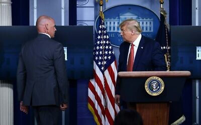 US President Donald Trump being removed by a member of the secret service from the Brady Briefing Room of the White House in Washington, DC, on August 10, 2020. (Brendan Smialowski / AFP)