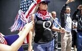 Conspiracy theorist QAnon demonstrators protest during a rally to re-open California and against Stay-At-Home directives on May 1, 2020 in San Diego, California. (Sandy Huffaker/AFP)