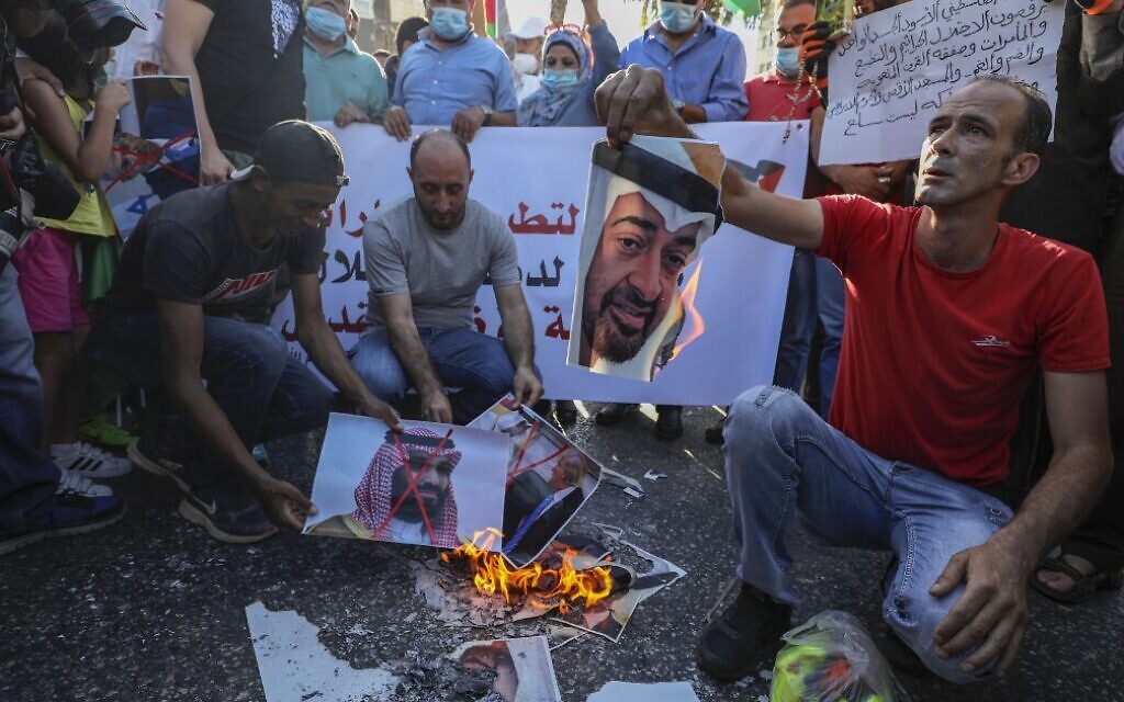 Palestinians in the West Bank city of Ramallah burn pictures of Emirati Crown Prince Sheikh Mohammed bin Zayed Al Nahyan (top) and Saudi Crown Prince Mohammed bin Salman, during a demonstration against the UAE-Israeli agreement to normalize diplomatic ties, August 15, 2020. (Abbas Momani/AFP) Palestinians in the West Bank city of Ramallah burn pictures of Emirati Crown Prince Sheikh Mohammed bin Zayed Al Nahyan (top) and Saudi Crown Prince Mohammed bin Salman, during a demonstration against the UAE-Israeli agreement to normalize diplomatic ties, August 15, 2020. (Abbas Momani/AFP)
