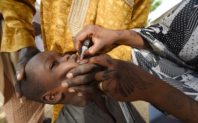 A Health worker administers a vaccine to a child during a vaccination campaign against polio at Hotoro-Kudu, Nassarawa district of Kano in northwest Nigeria, April 22, 2017. (Photo by PIUS UTOMI EKPEI / AFP) A Health worker administers a vaccine to a child during a vaccination campaign against polio at Hotoro-Kudu, Nassarawa district of Kano in northwest Nigeria, April 22, 2017. (Photo by PIUS UTOMI EKPEI / AFP)